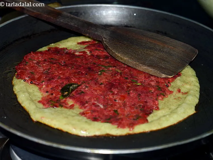 Step 37 – Spread one portion of the filling evenly over the dosa.