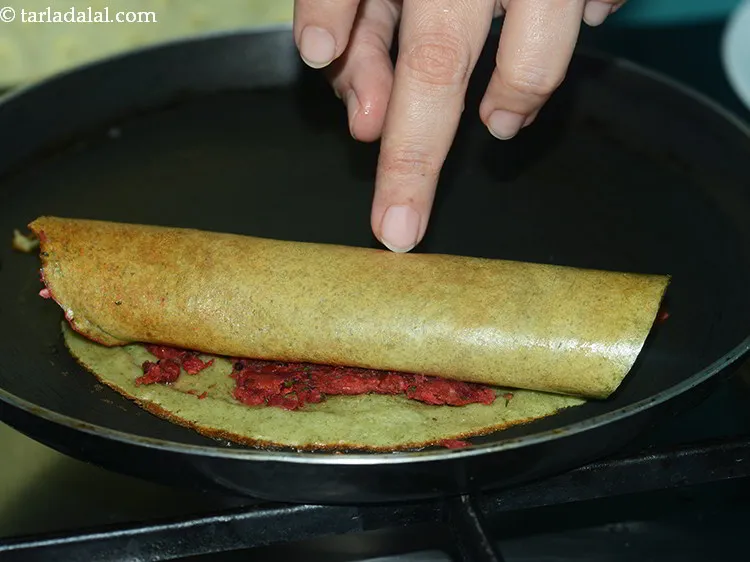 Step 38 – When the lower side of the dosa is lightly browned, fold it over.