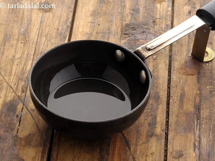 Step 20 – For tempering the <strong>moru moru dosa</strong> batter, heat the oil in a small non-stick pan.