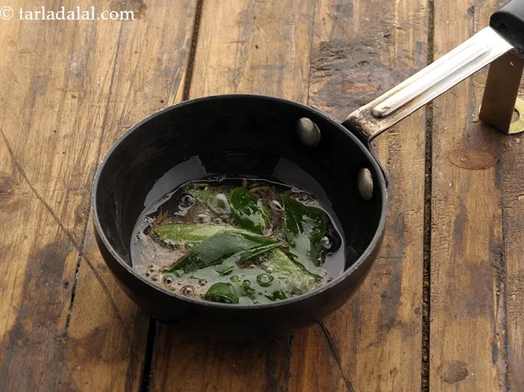 Step 22 – When the seeds crackle, add the curry leaves.