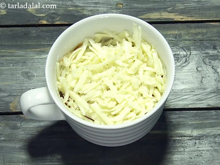 Step 12 – On top sprinkle 3 tbsp of grated mozzarella cheese. This cheese will give a gooey …