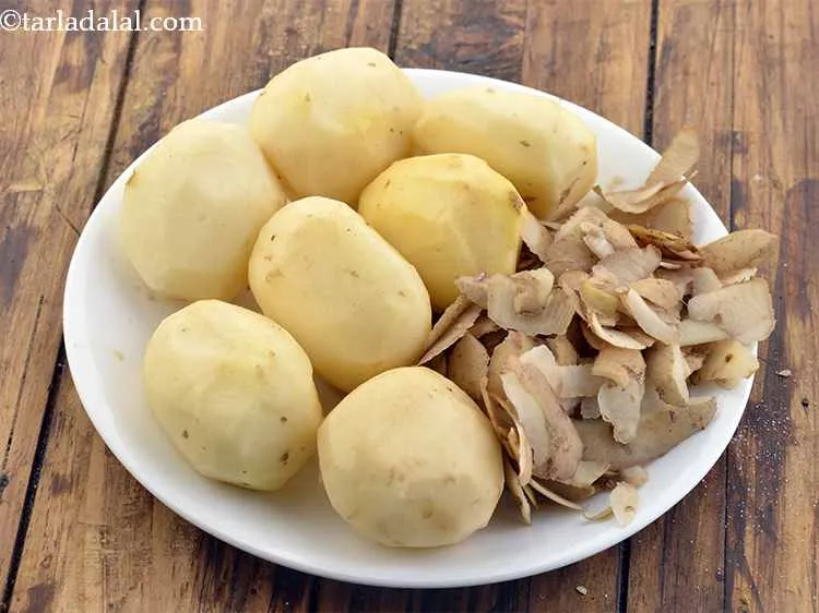 Step 3 – For the stuffed potatoes for <strong>Mughlai dum aloo</strong>, clean and wash 7 medium sized potatoes. …