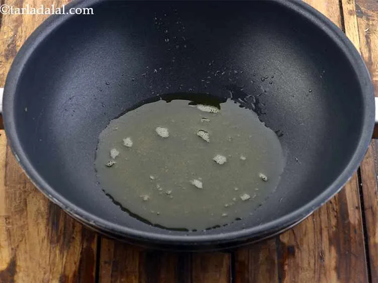 Step 34 – To make the <strong>Mughlai Dum Aloo gravy</strong>, take a kadhai and put the ghee into …