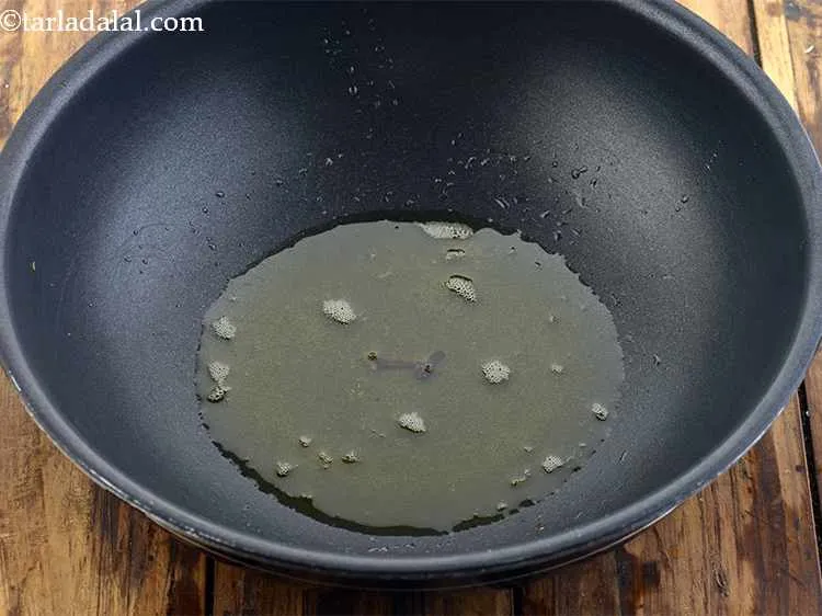 Step 35 – Once the ghee is hot, add the cloves.