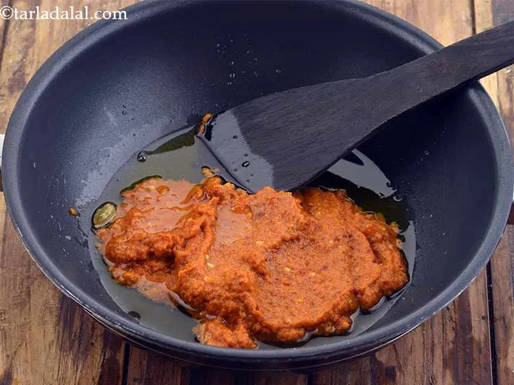 Step 38 – When they crackle, add the prepared paste.