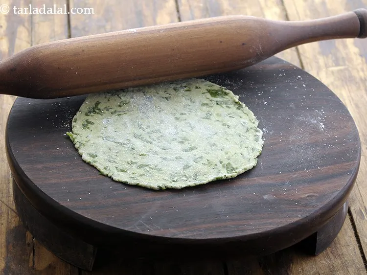 Step 19 – Roll each portion into a 100 mm. (4&rdquo;) diameter circle using little jowar flour for …