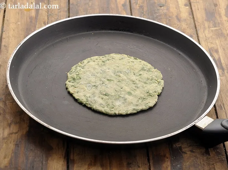 Step 20 – Heat a non-stick tava and place the rolled roti on it.