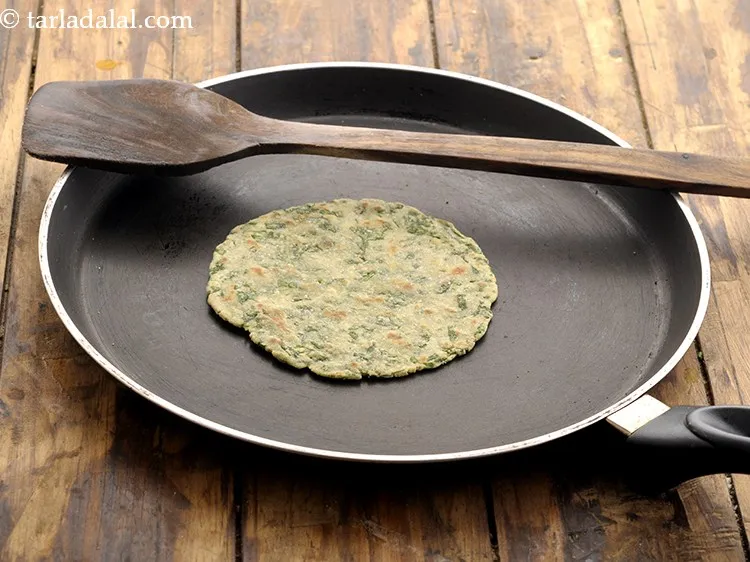 Step 21 – Cook the roti on one side till light brown spots appear on the side below.