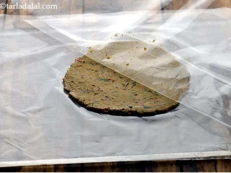 Step 22 – Lift the roti with plastic sheets and peel off the top plastic sheet.