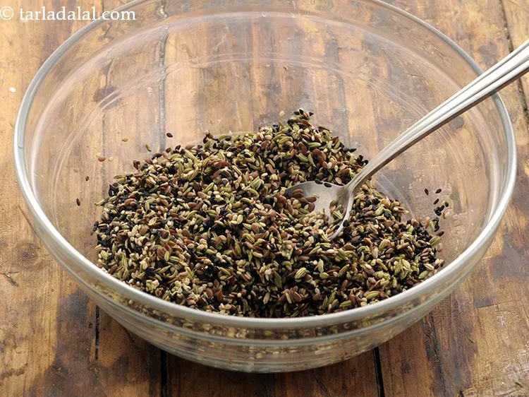 Step 13 – Mix all the ingredients of the <strong>multi seed mukhwas</strong> well using a spoon.&nbsp;
