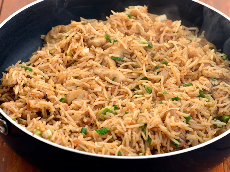 Step 33 – Switch off the flame, add the remaining ? cup spring onions and mix well.