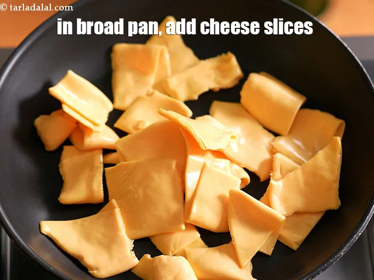 Step 19 – In a broad non-stick pan, add 12&nbsp;britannia&nbsp;<a href="https://www.tarladalal.com/glossary-cheese-slices-765i">cheese slices</a>&nbsp;, torn into pieces.&nbsp;