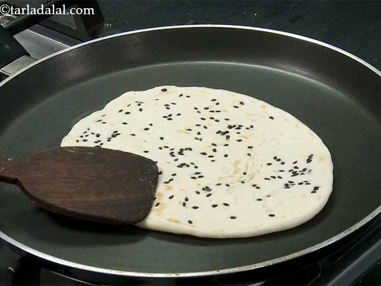 Step 14 – Cook it on a slow flame on one side till it puffs slightly and then …