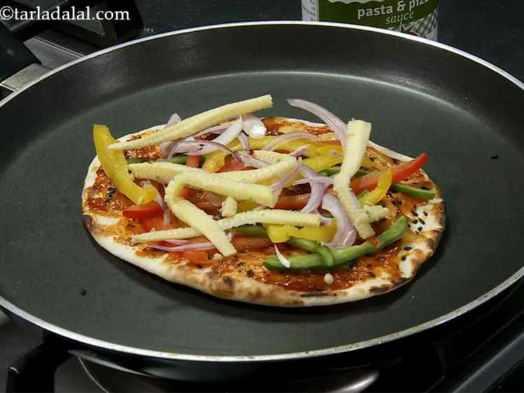 Step 21 – Finally arrange some sliced and blanched baby corn evenly over it. You can add any …