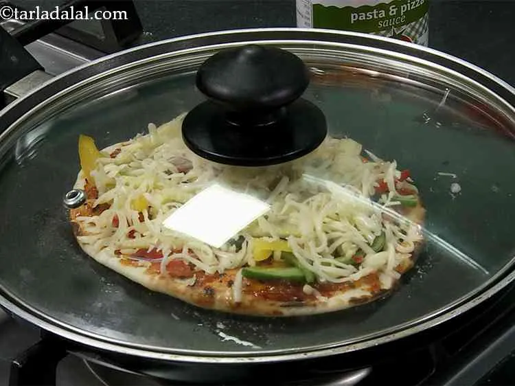 Step 23 – Spread 1 tsp of butter around the naanza, cover it with a lid and cook …