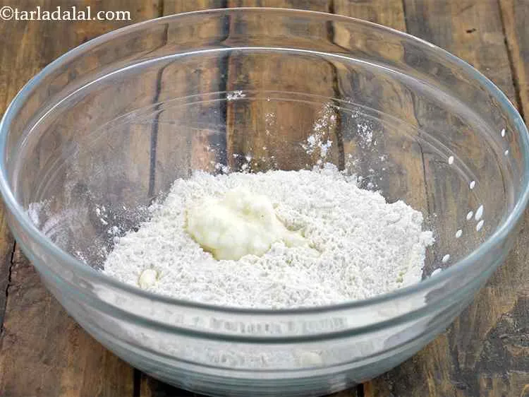 Step 4 – Combine the plain flour, curd and salt in a deep bowl. Make sure you take …