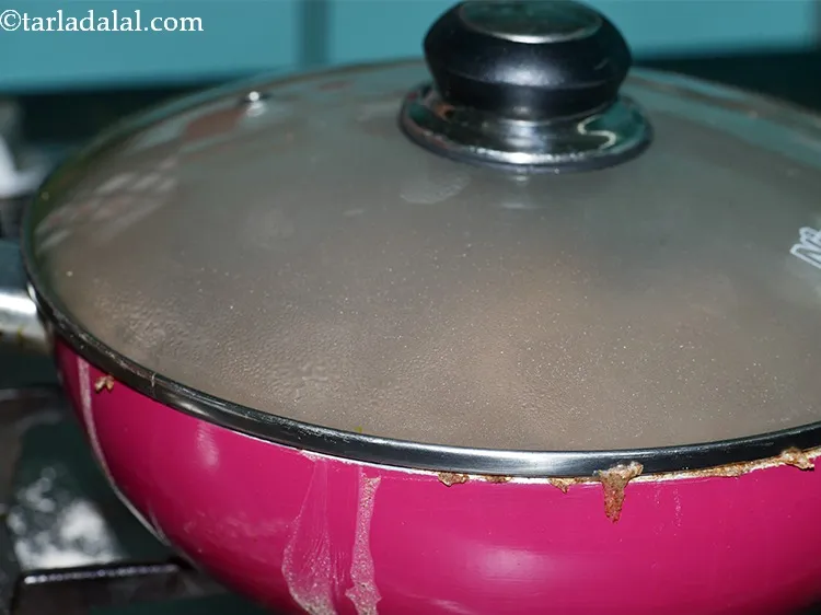 Step 12 – Cover the pan with a lid and cook the ragi khichu. You can even transfer …