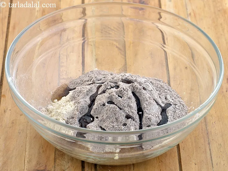 Step 3 – Add olive oil to the flours. Oil provides the necessary flakiness to the ragi nimki.