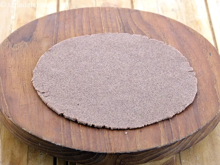 Step 7 – Roll out each portion into a thin round circle of 150 mm. (6?) diameter using …