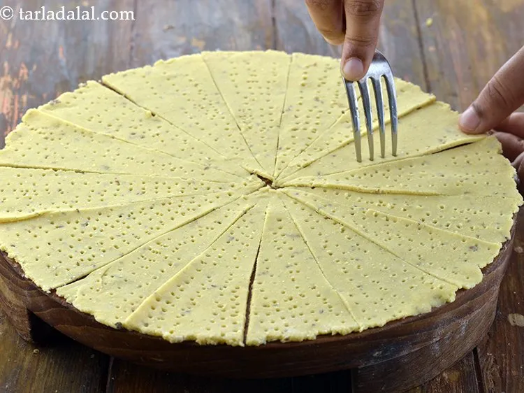 Step 15 – Take a fork and prick the rolled dough evenly. When we prick the dough, it …