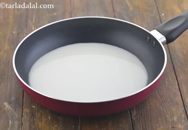 Step 12 – For the cheese sauce, take a broad non-stick pan and add the milk to it.