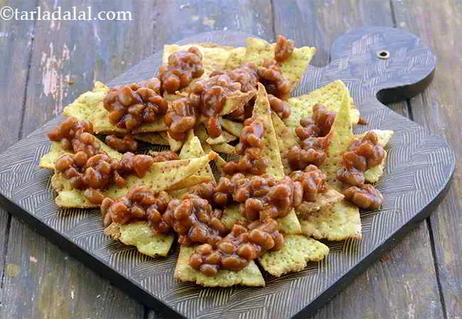Step 17 – Pour &frac12; cup of baked beans evenly all over the corn chips. The baked beans …