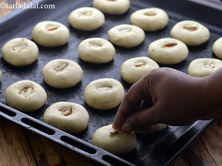Step 18 – Garnish each <strong>nankhatai</strong> with a few almond slivers. You can even form a dent in …