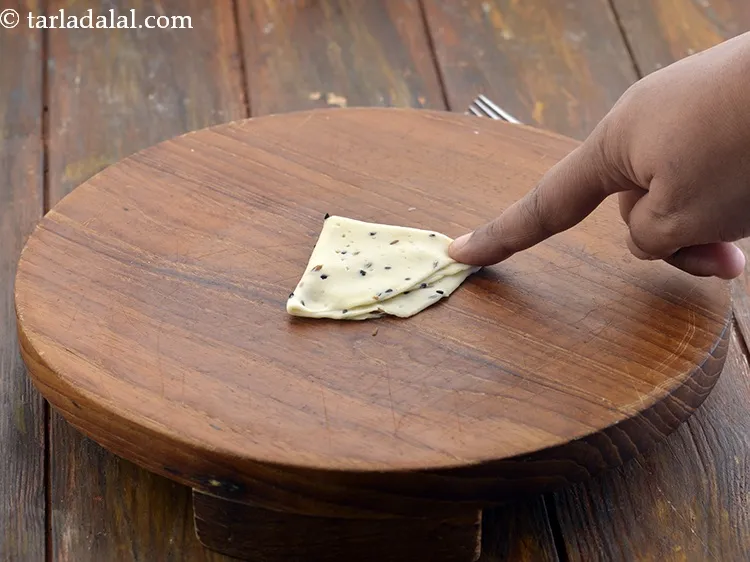 Step 28 – Fold into half to form a semi- circle and fold again to form a triangle …