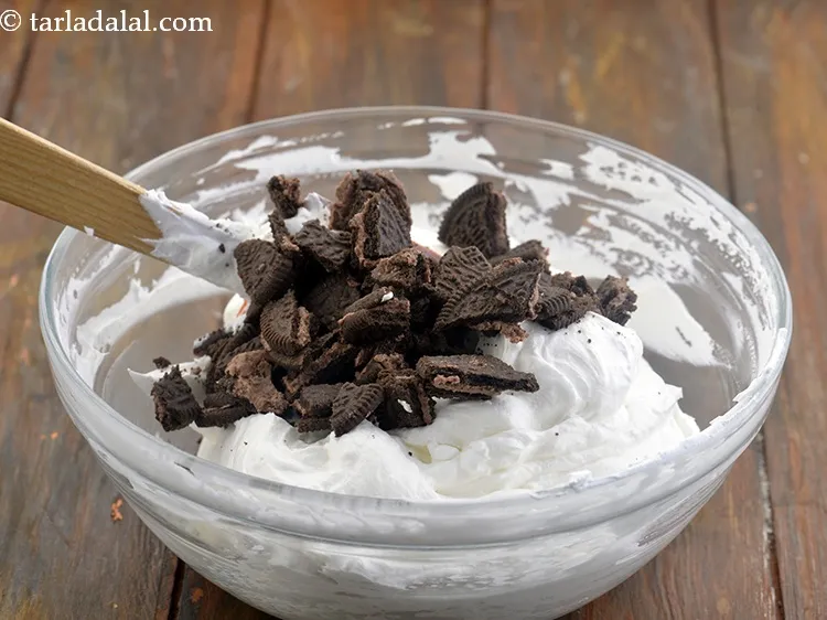 Step 16 – Add 1/2 cup&nbsp;coarsely&nbsp;<a href="https://www.tarladalal.com/glossary-crushed-oreo-biscuit-1224i">crushed oreo cookies</a>. To coarsely cruch the Oreo cookies, place them on …