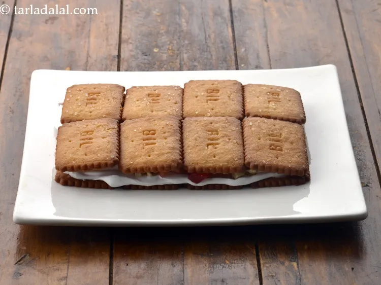 Step 14 – Dip the remaining 8 biscuits in the orange juice one by one and again place …