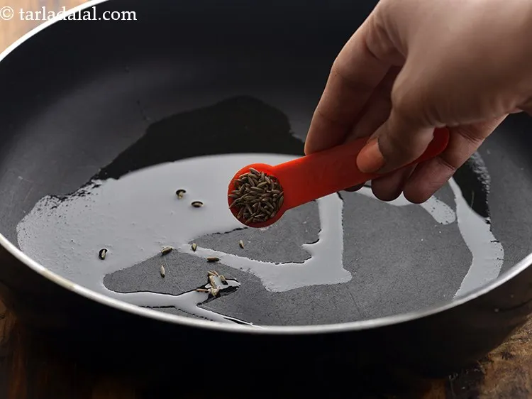 Step 3 – Once the oil is hot, add cumin seeds.