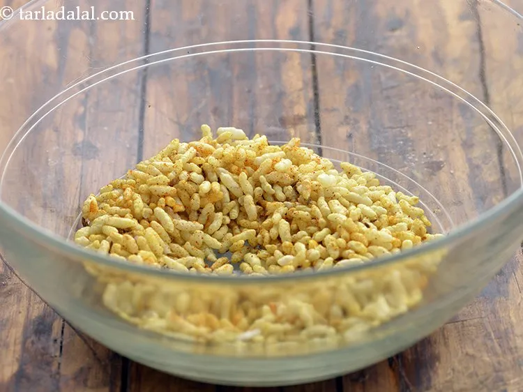 Step 12 – To serve the <strong>nutritious fruit bhel</strong>, in a bowl take the masala puffed rice. We …