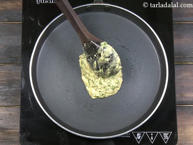Step 33 – Pour a ladleful of the batter on the tava (griddle).