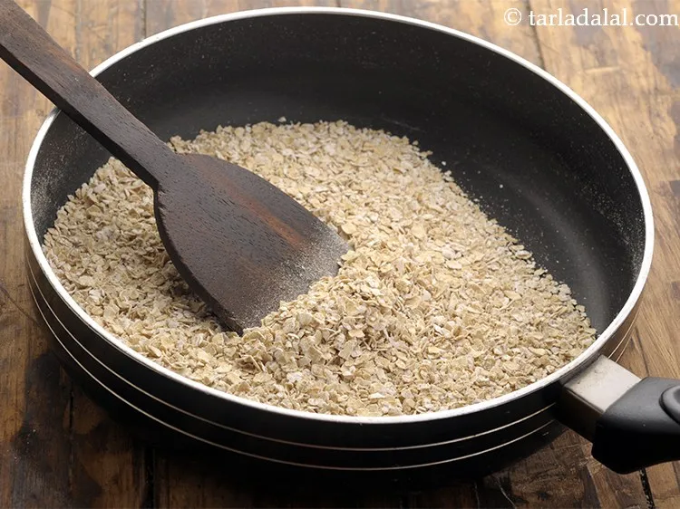 Step 10 – Dry roast oats on a <strong>low flame</strong> ( to&nbsp;medium flame) <strong>for 3 minutes while stirring …