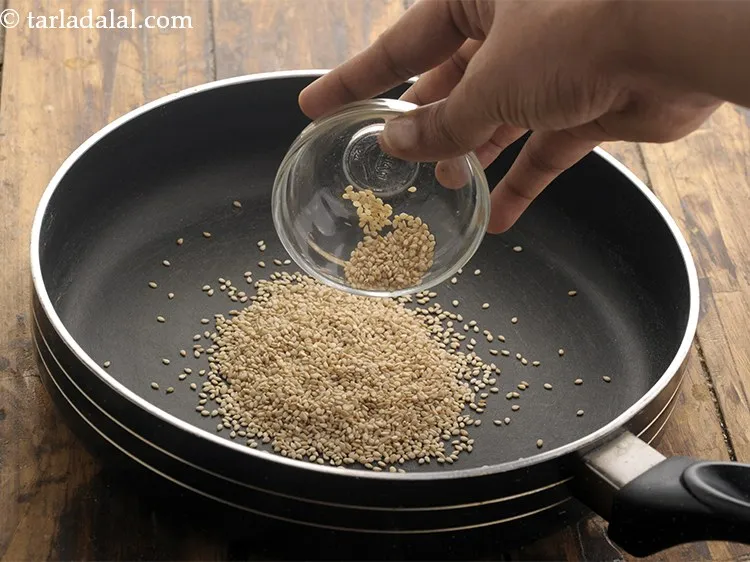 Step 12 – Meanwhile, place <meta charset="UTF-8" />2 tbsp&nbsp;<a href="glossary-sesame-seeds-til-gingelly-seeds-612i">sesame seeds (til)</a> in the same non-stick pan.&nbsp;