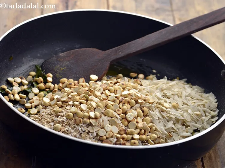Step 14 – Also, add chana dal. You can even add roasted sesame seeds, peanuts, cashew nuts, raisins, …