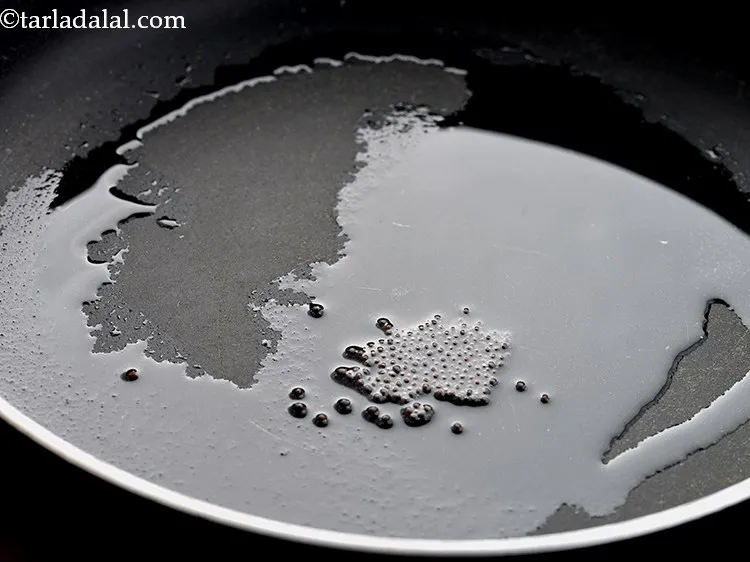 Step 8 – Once the oil is hot, add mustard seeds.