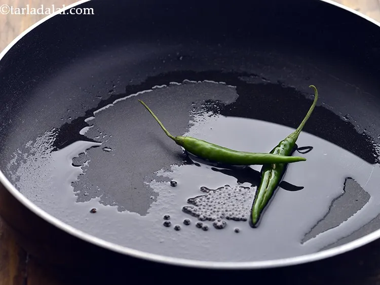 Step 9 – Add green chillies. To make it spicier, add more chillies.