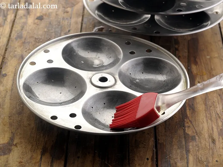 Step 17 – Before steaming the h<strong>ealthy oats idli for diabetics</strong>, grease the idli moulds using oil. Also, …