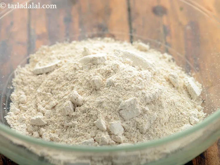 Step 5 – Transfer the oats-urad dal powder to a deep bowl for the nutritious oats idli.