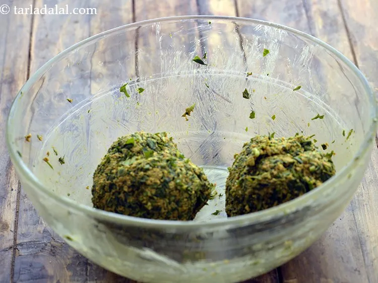 Step 15 – Divide the oats fenugreek muthia dough into 2 equal portions.