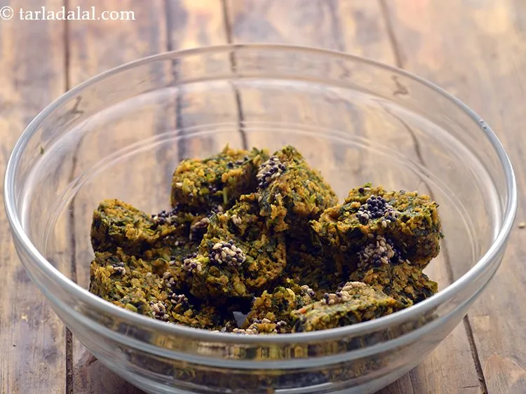 Step 25 – Pour the tempering over the oats muthia pieces and toss it lightly.