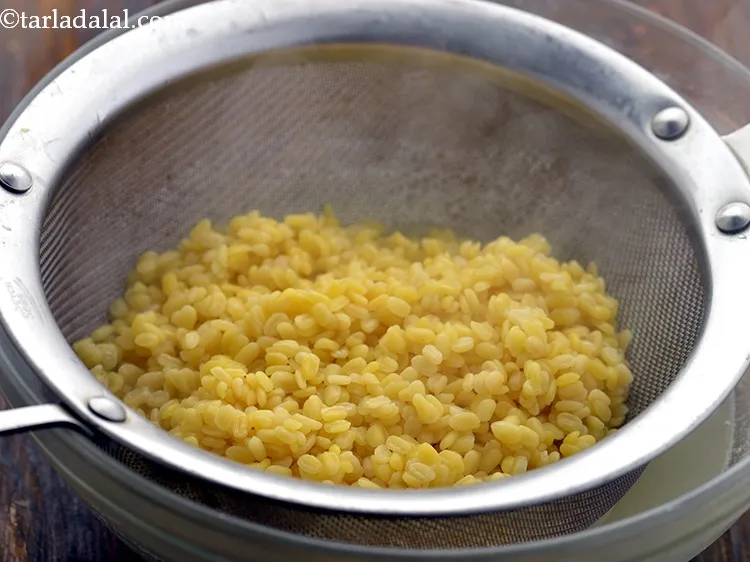 Step 5 – Drain the dal using a sieve. While grinding the moong dal there should be almost …