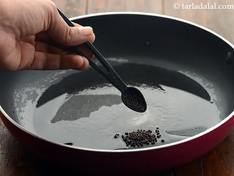 Step 11 – Once the oil is hot, add the mustard seeds.