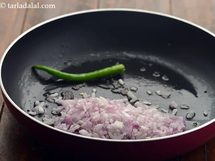 Step 13 – When the seeds crackle, add the onions.
