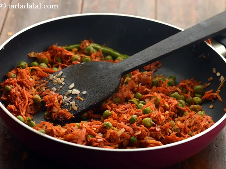 Step 21 – Mix well and cook all the ingredients of <strong>healthy oats matar dosa</strong> on a medium …