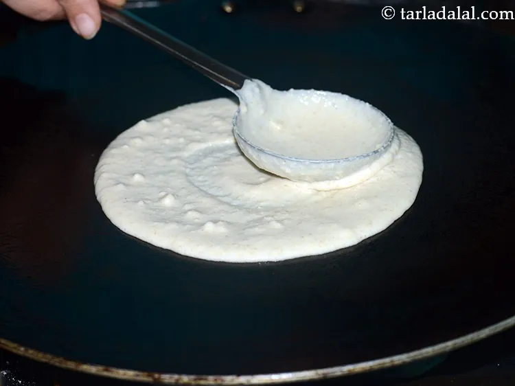 Step 27 – Move the spoon in a circular motion to make a 175 mm. (7&rdquo;) round dosa.