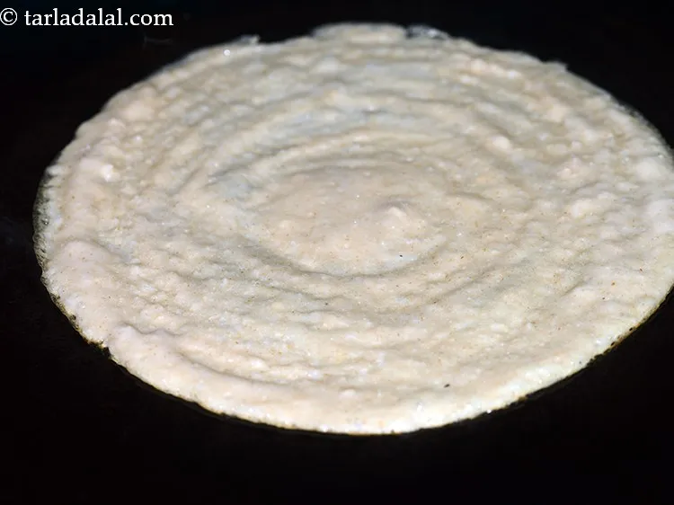 Step 29 – Cook on a medium flame till the <strong>easy oats dosa</strong> turns light brown in colour.