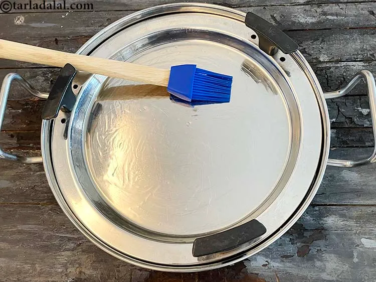 Step 22 – On top of the grease the dhokla plate with some oil. We have used a …