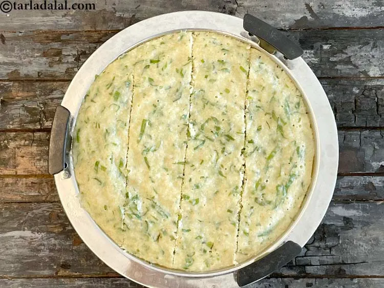 Step 27 – Cut a vertical lines accross the dhokla first. We want to cut into square shape …